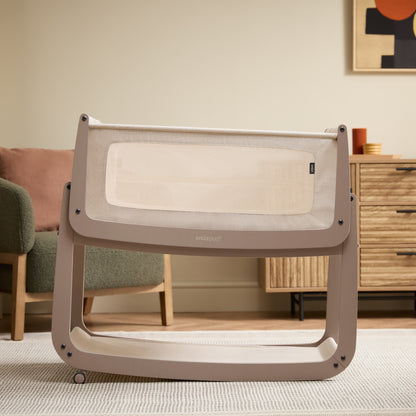 A Mocha Snuzpod5 bedside crib designed for infants, showcasing a modern and safe sleeping environment.