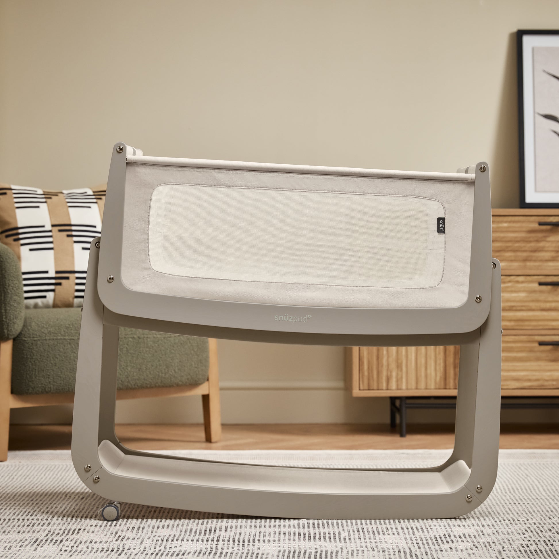 A Pebble Snuzpod5 bedside crib designed for infants, showcasing a modern and safe sleeping environment.
