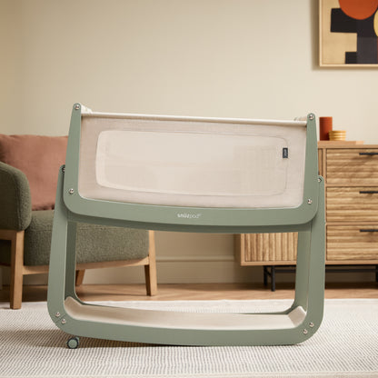 A Sage Snuzpod5 bedside crib designed for infants, showcasing a modern and safe sleeping environment.