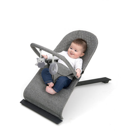 Stylish baby bouncer in grey melange, equipped with a three-position recline and a toy bar for playful engagement.
