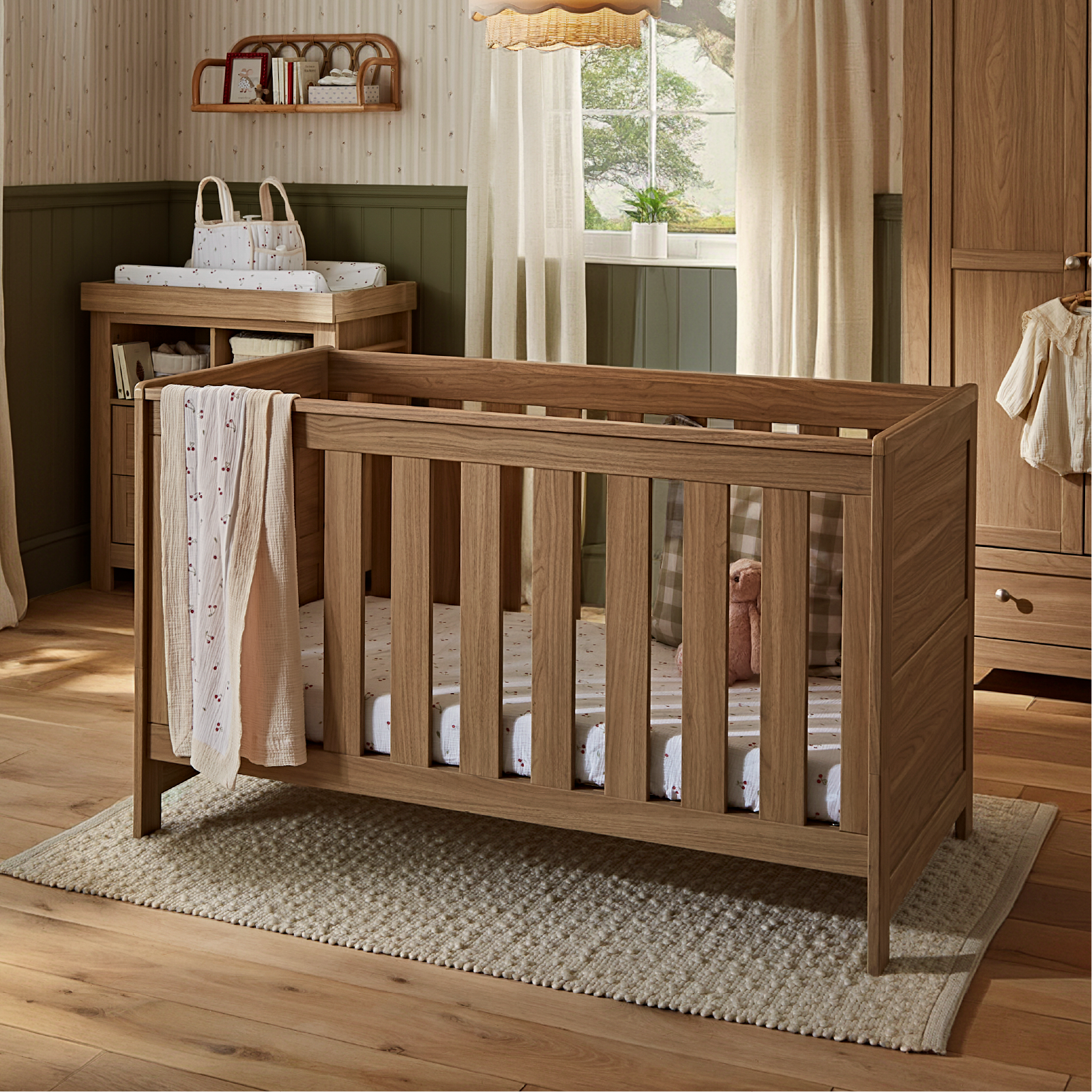CuddleCo Burford cot bed in an oak finish.