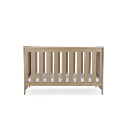 CuddleCo Burford cot bed in an oak finish. Mattress not included.
