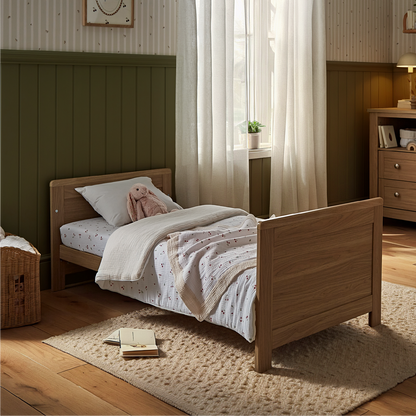 CuddleCo Burford cot bed in an oak finish.