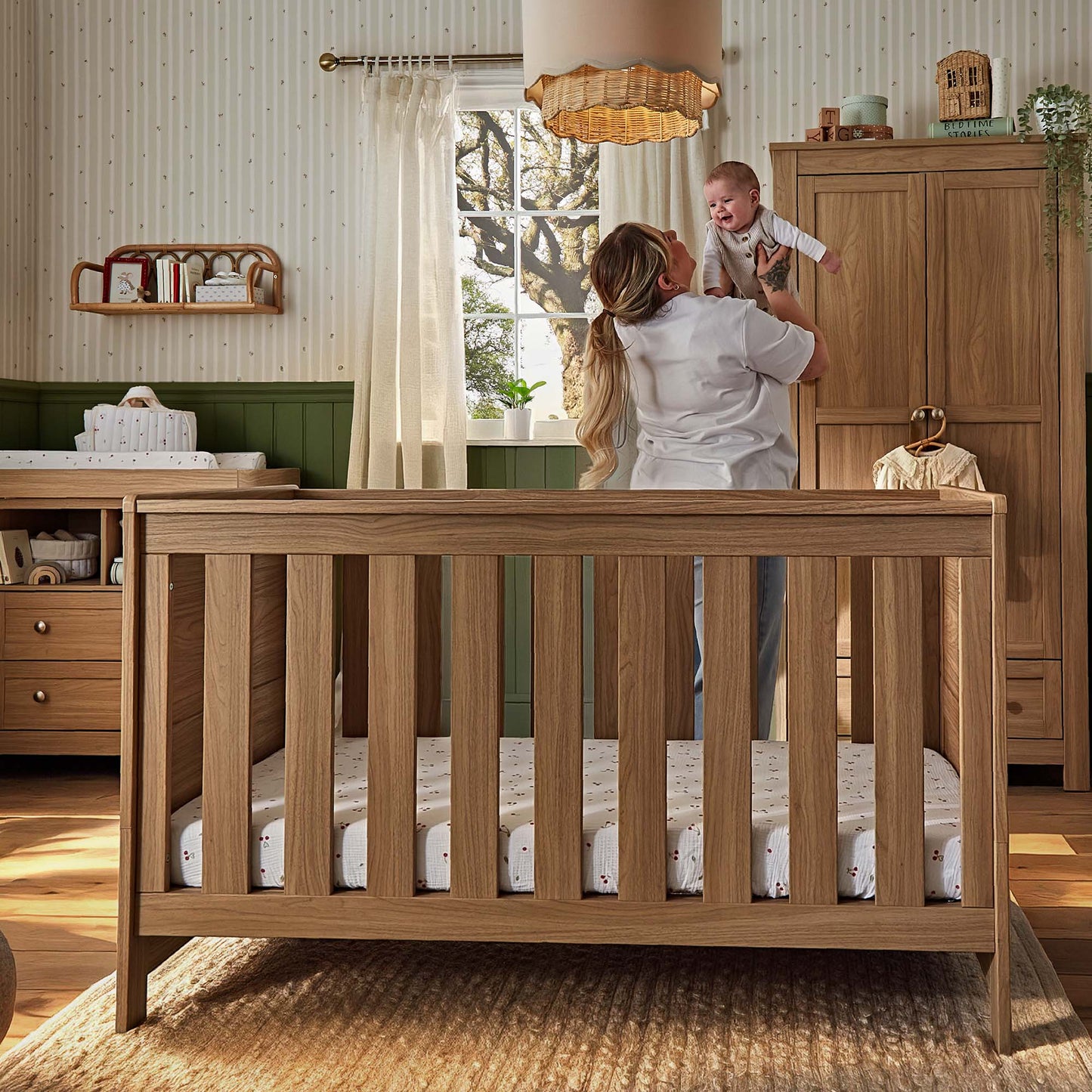 CuddleCo Burford cot bed in an oak finish.