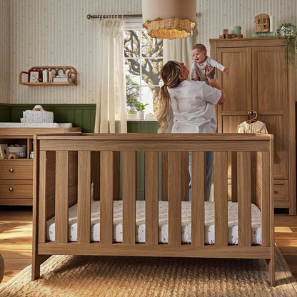 CuddleCo Burford cot bed in an oak finish.