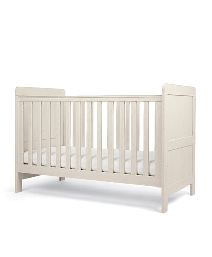 Cot bed with adjustable heights in stone colour, complete with snuz pro mattress.