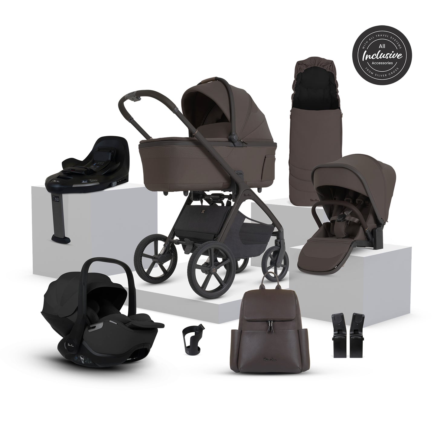 A multi-piece silver cross cove 2 travel system set in dark brown and black, displayed on white pedestals against a white background. The set includes a stroller, bassinet, car seat, infant seat, stroller cover, backpack, car seat belt, and a circular 'All Inclusive Set' badge.