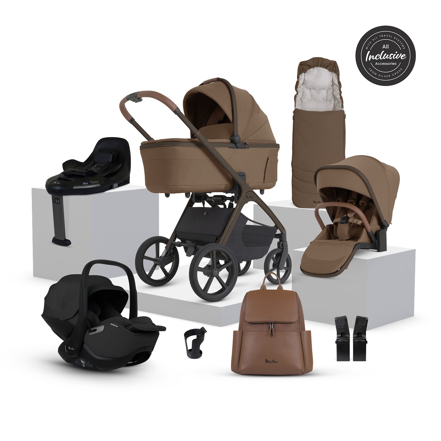 A multi-item silver cross cove 2 travel system set in brown and black, displayed on white pedestals against a white background. The set includes a stroller, bassinet, car seat in black, infant car seat, footmuff, bassinet cover, backpack, harness, and a circular 'All Inclusive Set' badge.