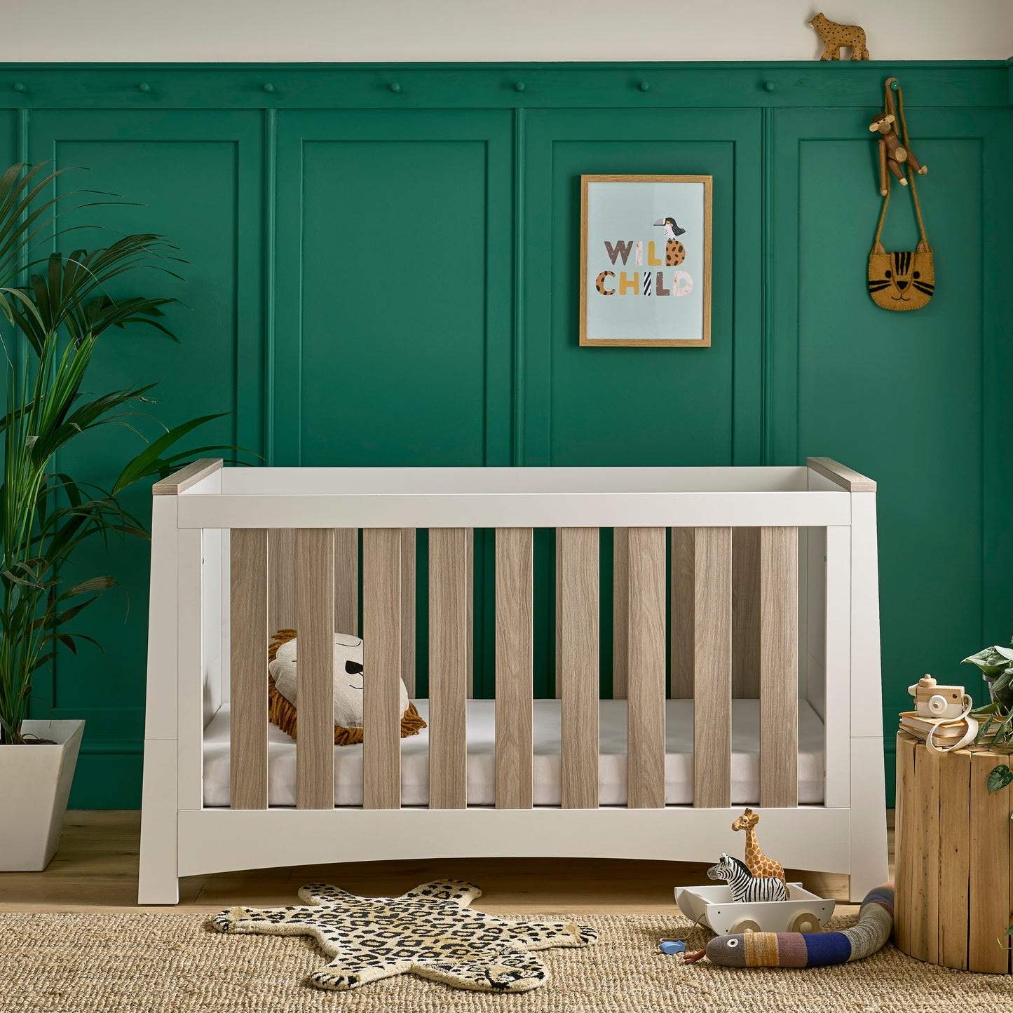 Ada cot bed in white and ash within a nursery