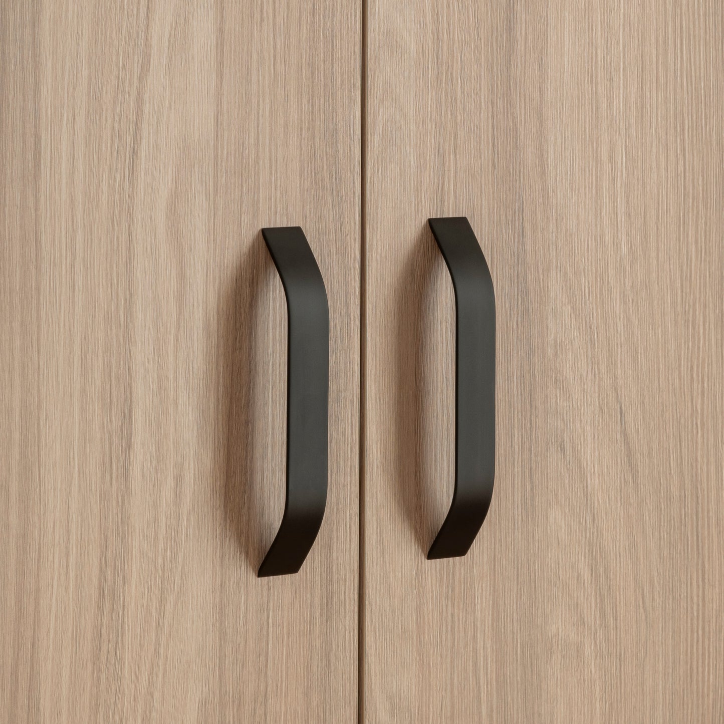 Close-up image of an Isla wardrobe with black handles.