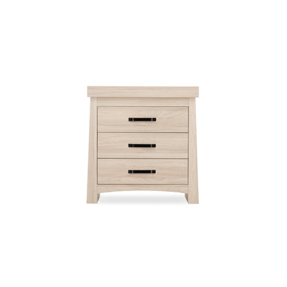 The Isla dresser, featuring an ash finish and stylish black handles, is a perfect blend of modern and traditional design, making it a versatile addition to any nursery.