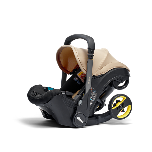 A stylish Doona car seat in Sahara Sand, for a modern infant safety solution.