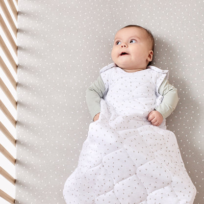 Baby lying comfortably in White Rice sleep bag