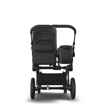 Midnight Black Bugaboo Donkey 5 stroller with seat and carrycot fabrics, designed for easy folding and adaptable for duo or twin configurations.