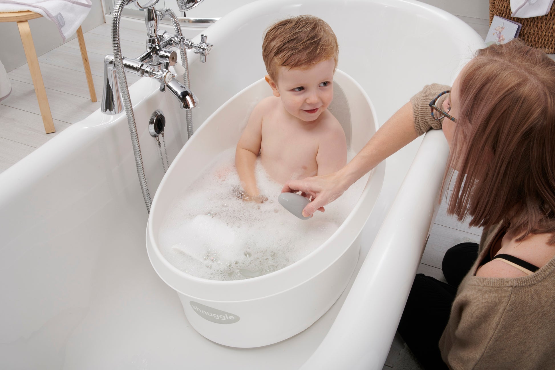 Pebbly Bath Thermometer beside baby in shnuggle bath