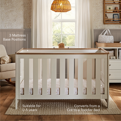 CuddleCo Burford cot bed in white with oak trim.