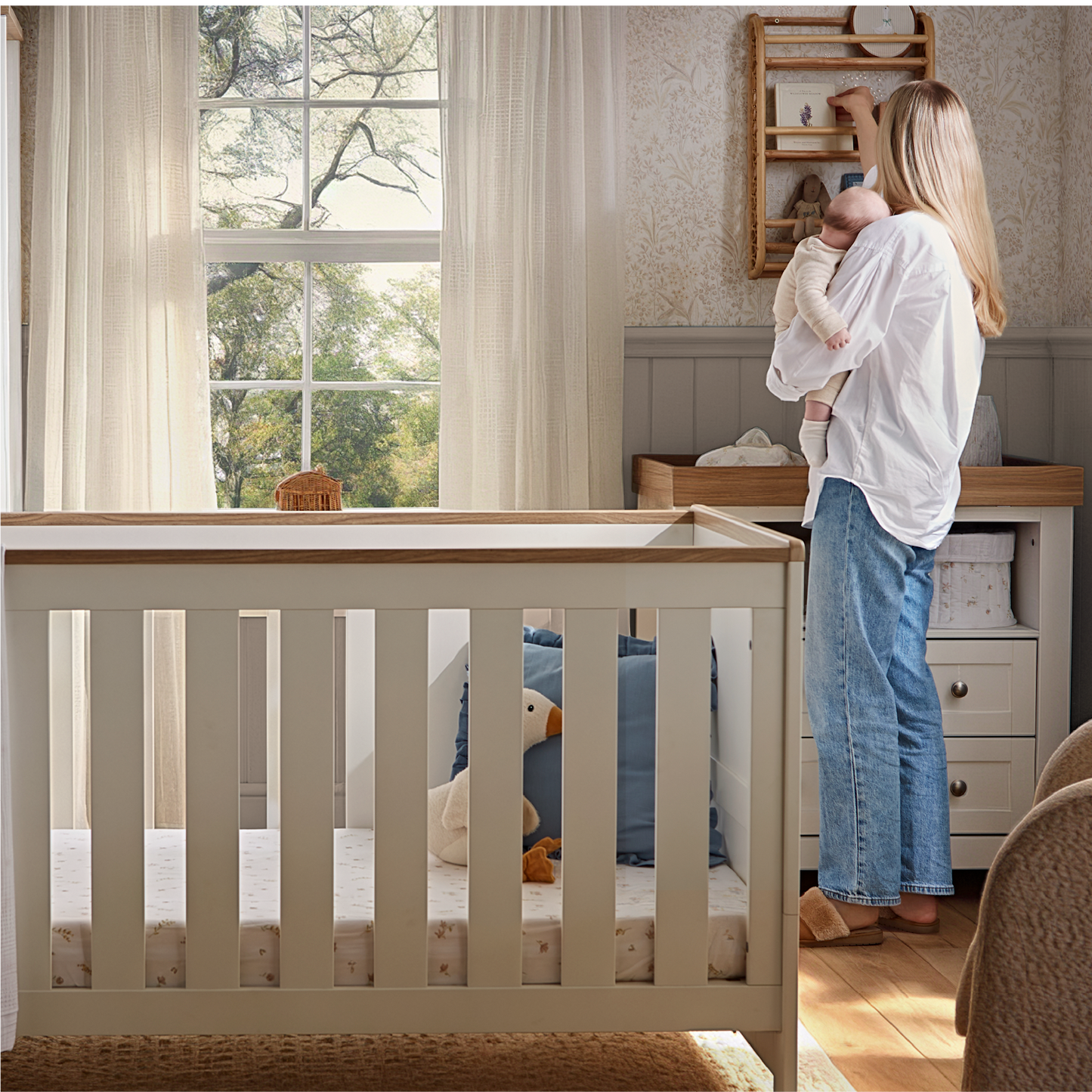 CuddleCo Burford cot bed in white with oak trim.