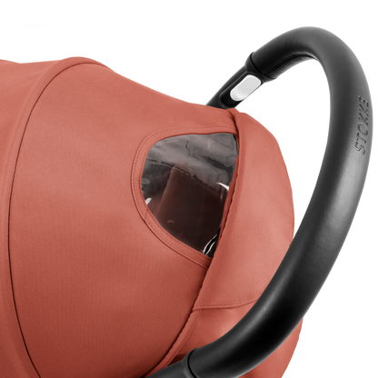 A compact yoyo 5 stroller with a rust-orange canopy and seat lining, a black frame, and black wheels, shown on a plain white background.
