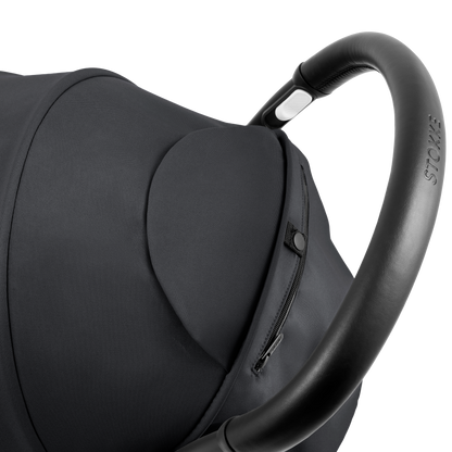 A compact yoyo 5 stroller with a black canopy and seat lining, a black frame, and black wheels, shown on a plain white background.