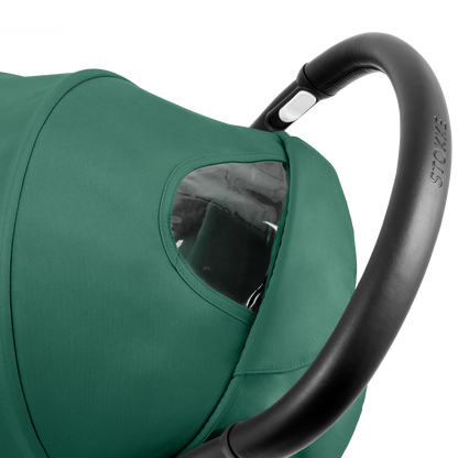 A compact yoyo 5 stroller with a green canopy and seat lining, a black frame, and black wheels, shown on a plain white background.