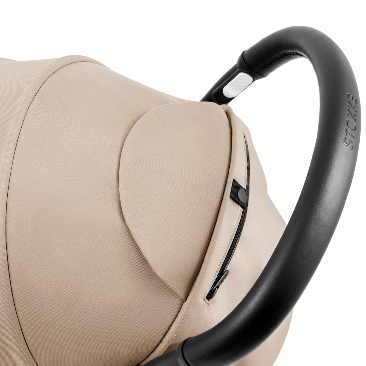 A compact baby stroller with a beige canopy and beige padded seat, with a blacked out chassis, shown on a plain white background.