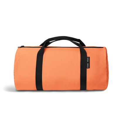 A stroller with a orange colored padded footmuff, cream fleece lining, and a black frame, shown from the front on a white background.