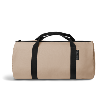 A stroller with a beige colored padded footmuff, cream fleece lining, and a black frame, shown from the front on a white background.