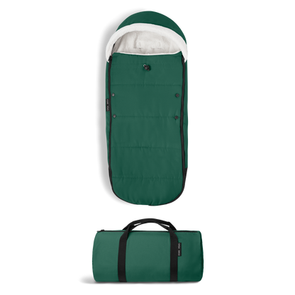 A stroller with a forest green colored padded footmuff, cream fleece lining, and a black frame, shown from the front on a white background.
