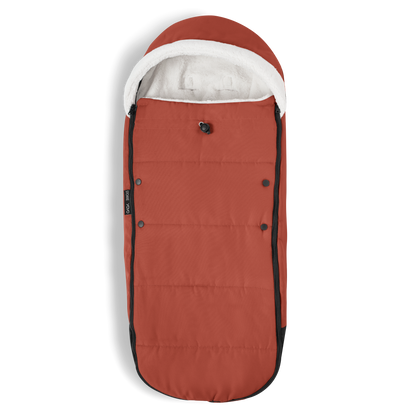 A stroller with a rust-colored padded footmuff, cream fleece lining, and a black frame, shown from the front on a white background.