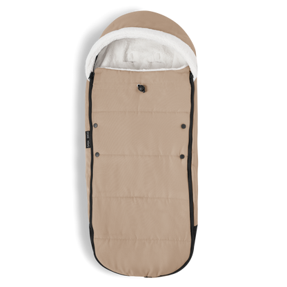 A stroller with a beige colored padded footmuff, cream fleece lining, and a black frame, shown from the front on a white background.