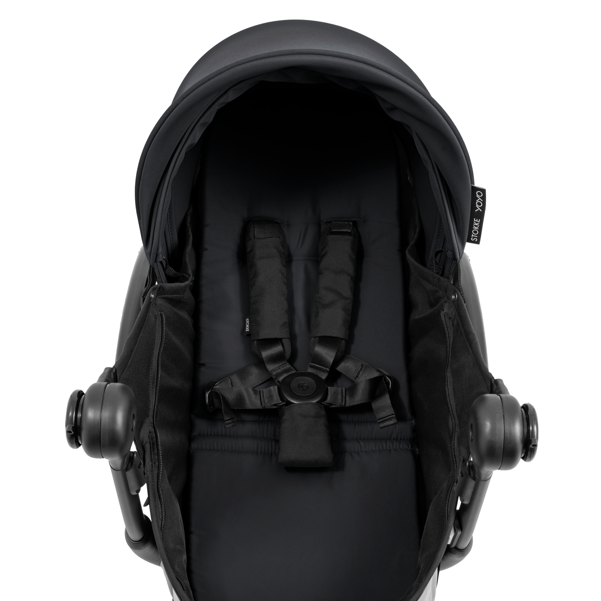 A black stroller newborn travel system shown in black, with a stroller behind it to demonstrate compatibility, on a clean white background.