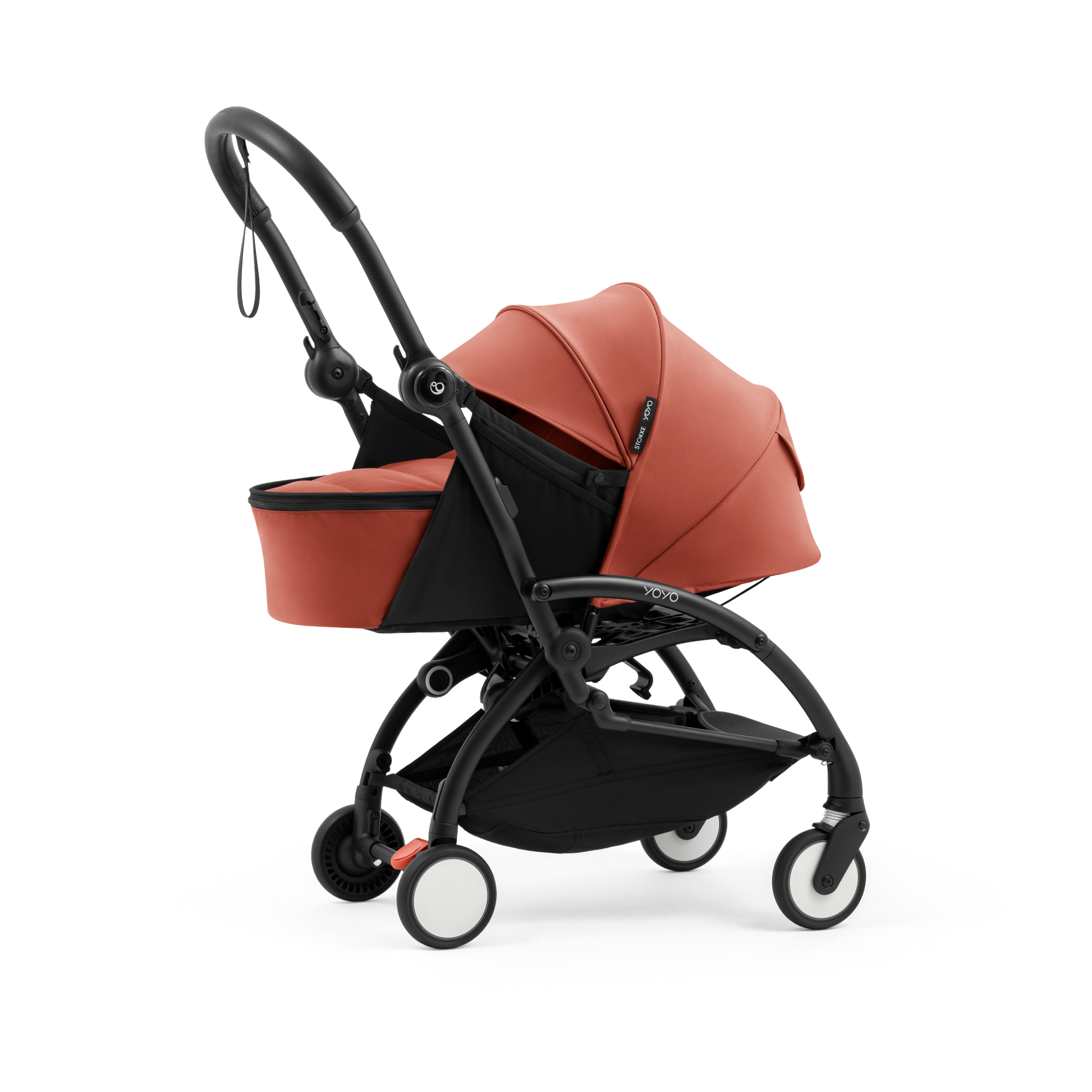 A yoyo stroller bassinet attachment set in terracotta orange and black, shown mounted on a stroller frame against a solid white background.