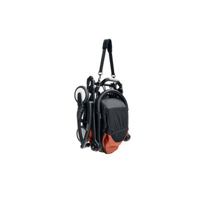 A yoyo stroller bassinet attachment set in terracotta orange and black, shown mounted on a stroller frame against a solid white background.