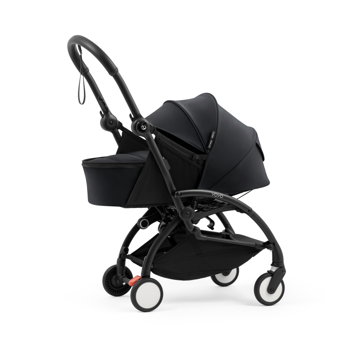 A black stroller newborn travel system shown in black, with a stroller behind it to demonstrate compatibility, on a clean white background.