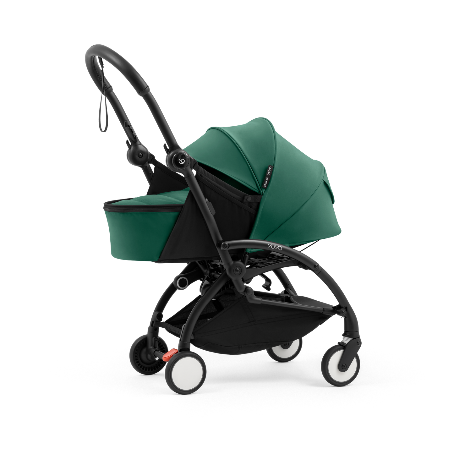 A black stroller newborn travel system shown in green, with a stroller behind it to demonstrate compatibility, on a clean white background.