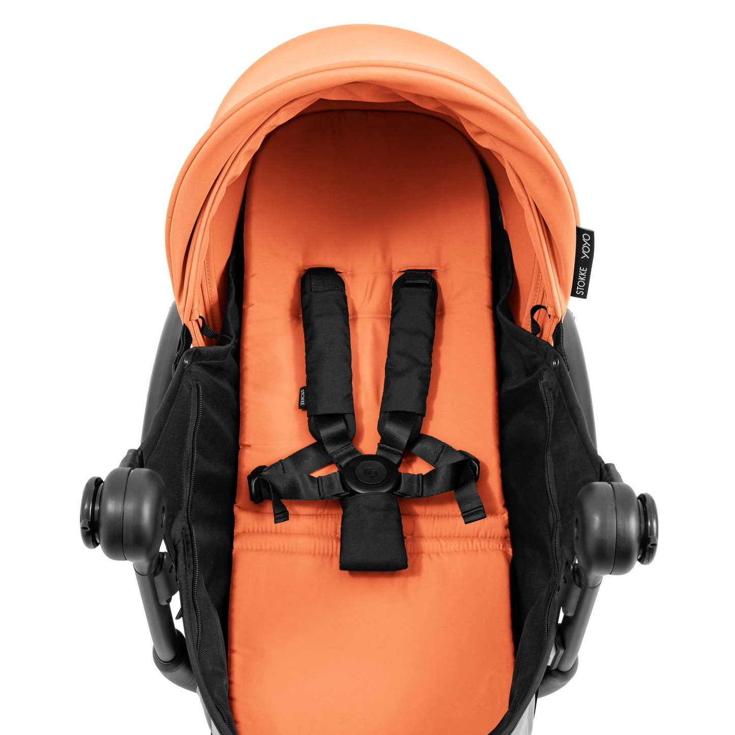 A black stroller newborn travel system shown in orange, with a stroller behind it to demonstrate compatibility, on a clean white background.