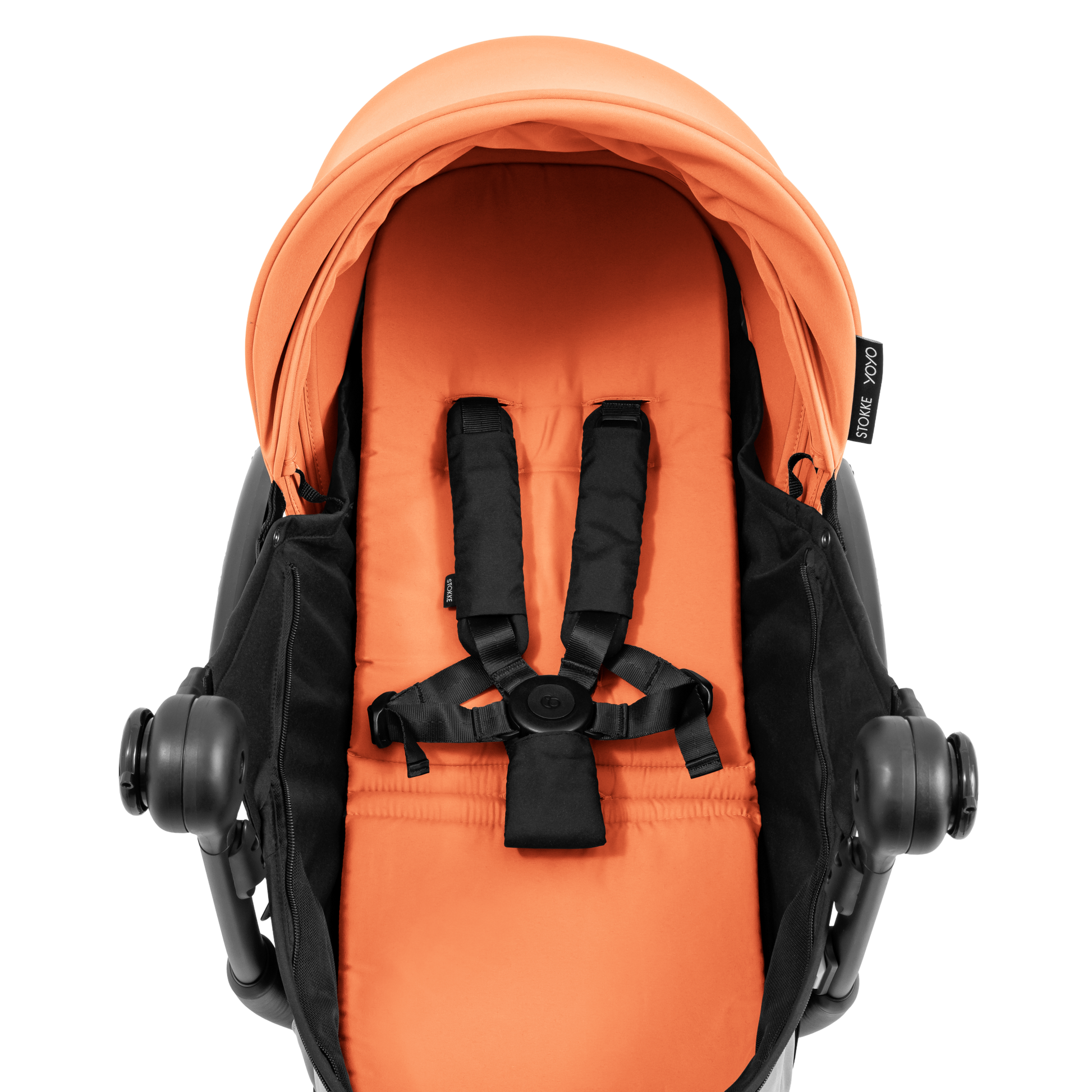 A black stroller newborn travel system shown in orange, with a stroller behind it to demonstrate compatibility, on a clean white background.
