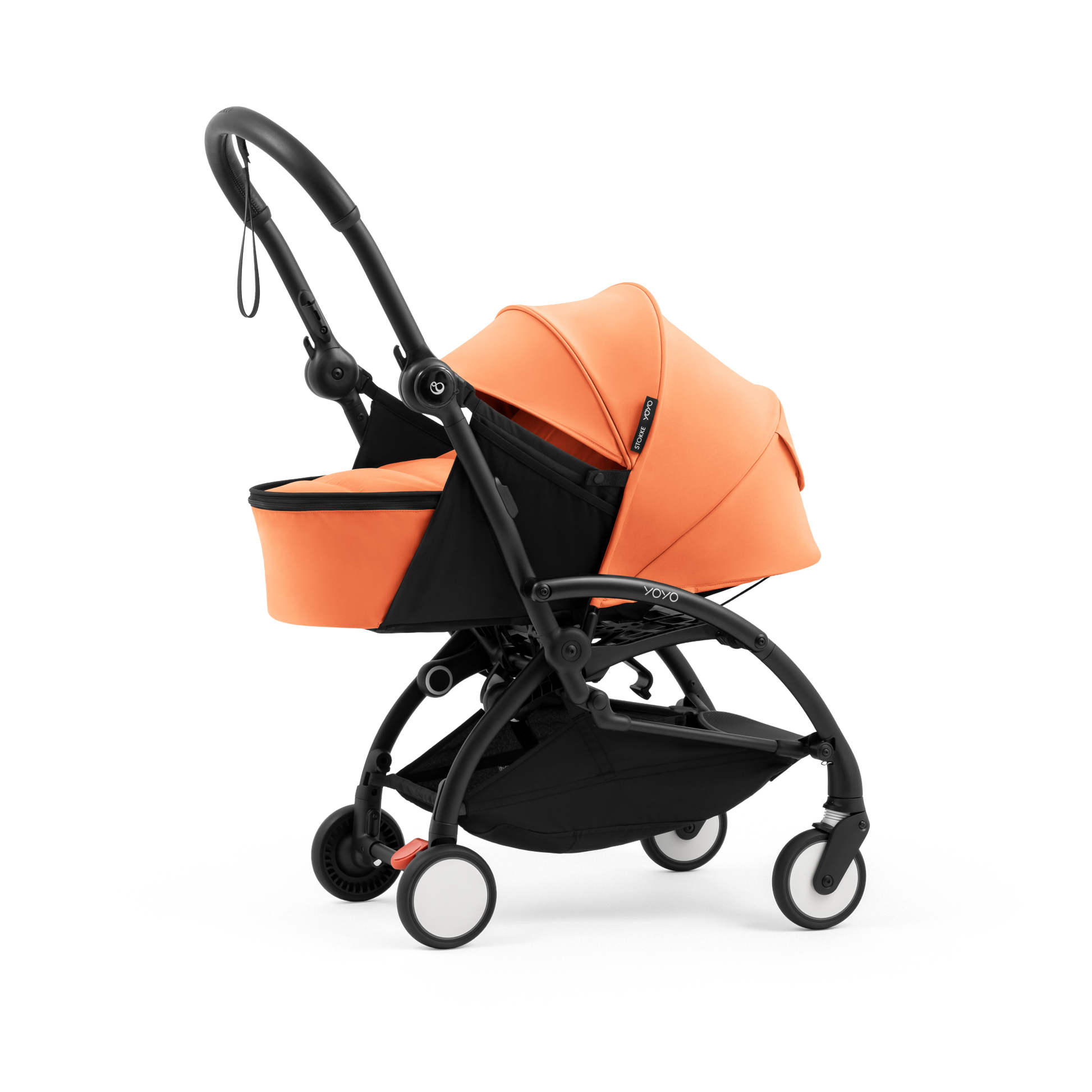 A black stroller newborn travel system shown in orange, with a stroller behind it to demonstrate compatibility, on a clean white background.
