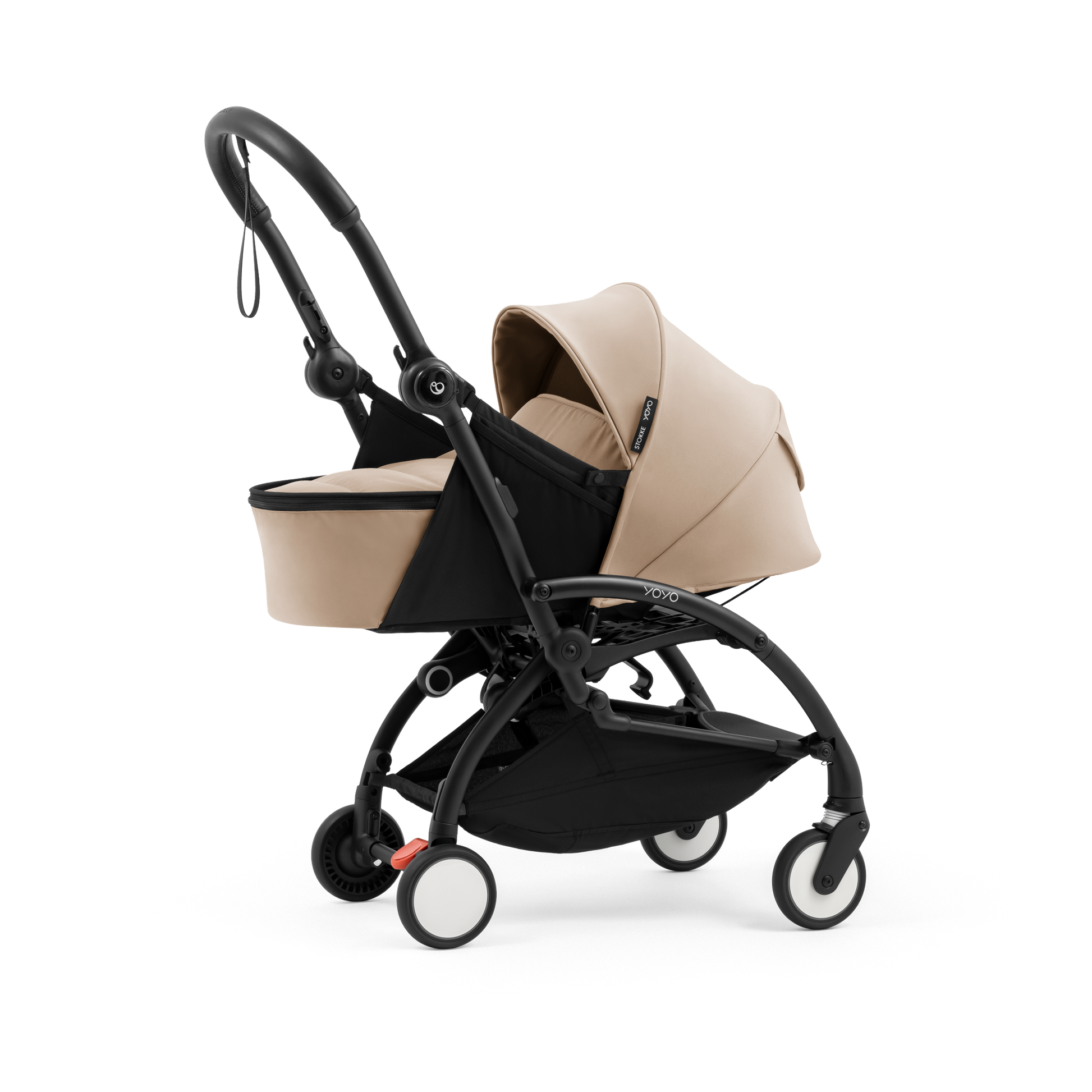 A yoyo stroller bassinet attachment set in beige and black, shown mounted on a stroller frame against a solid white background.