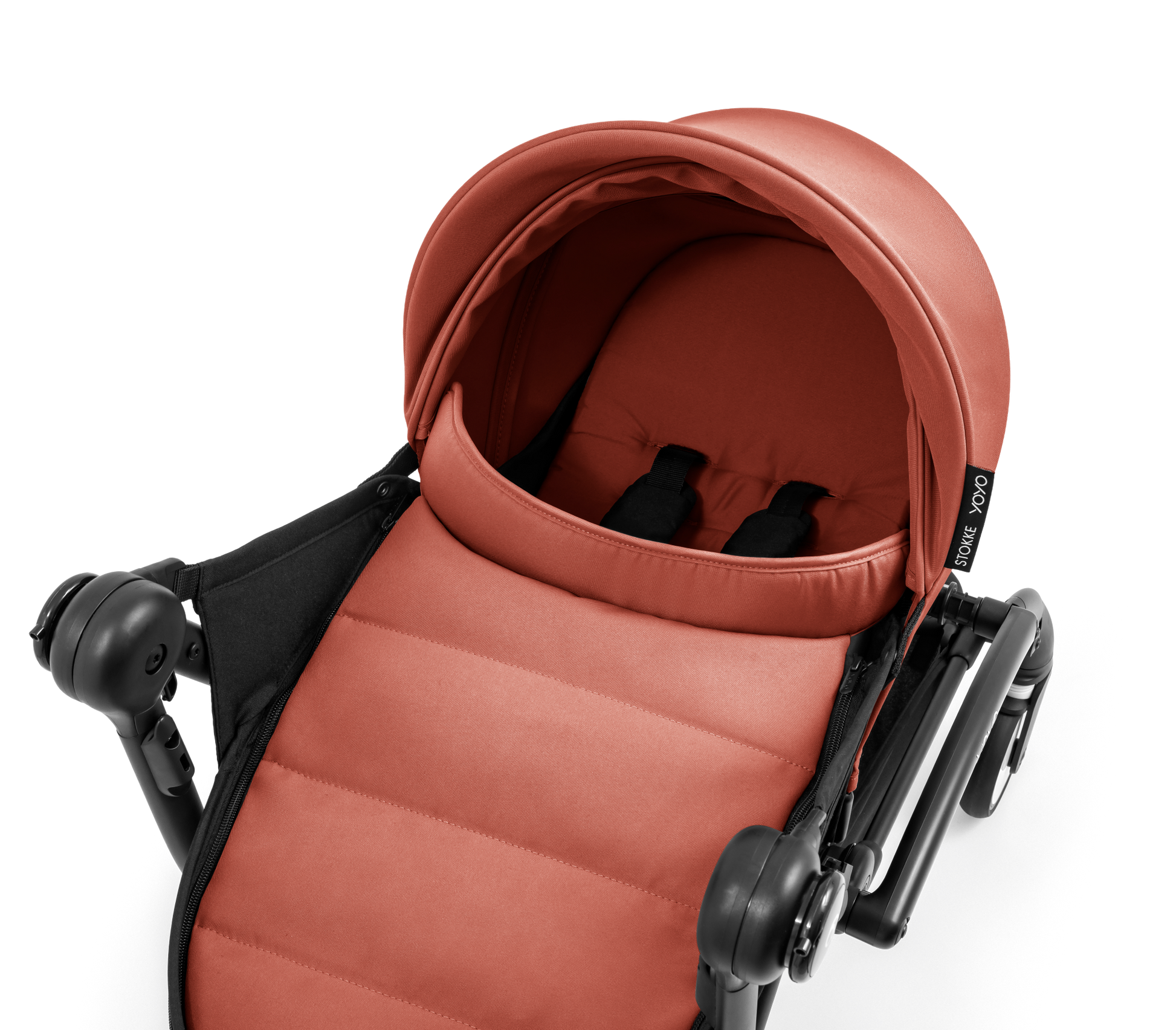 A yoyo stroller bassinet attachment set in terracotta orange and black, shown mounted on a stroller frame against a solid white background.
