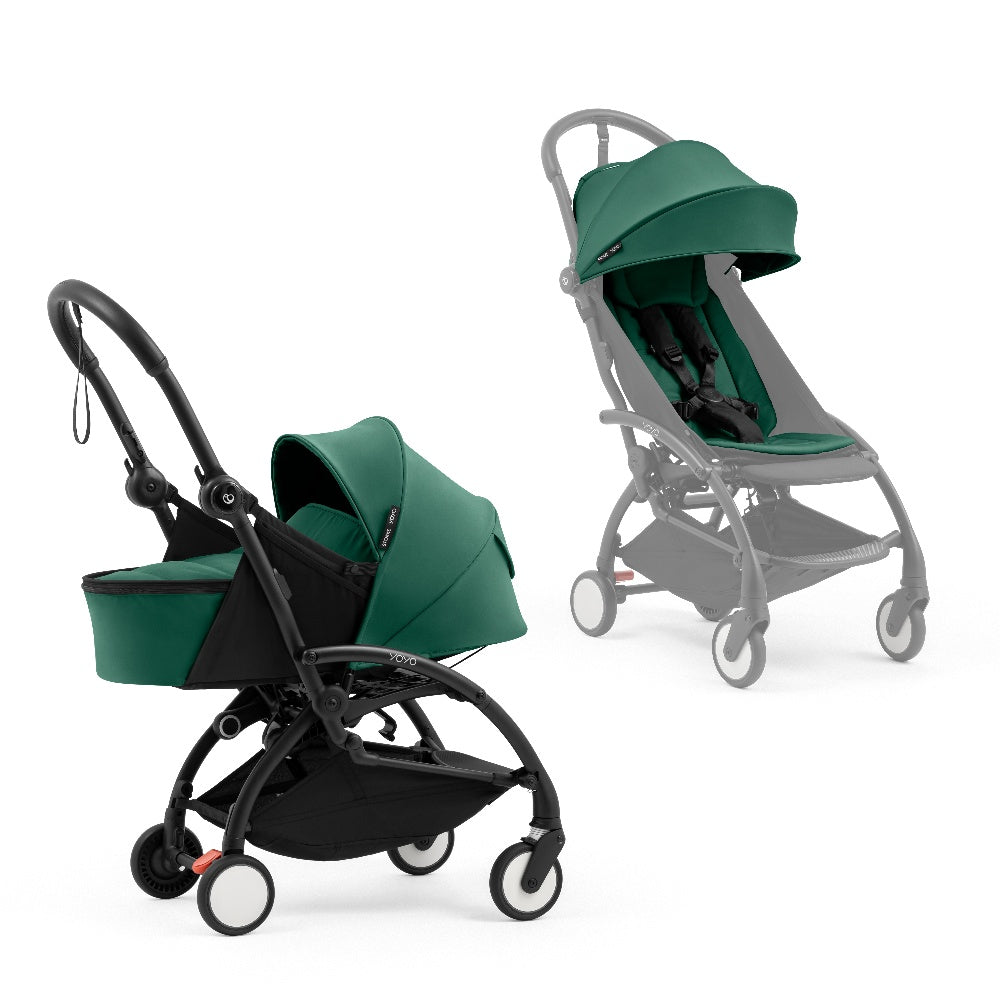 A black stroller newborn travel system shown in green, with a stroller behind it to demonstrate compatibility, on a clean white background.