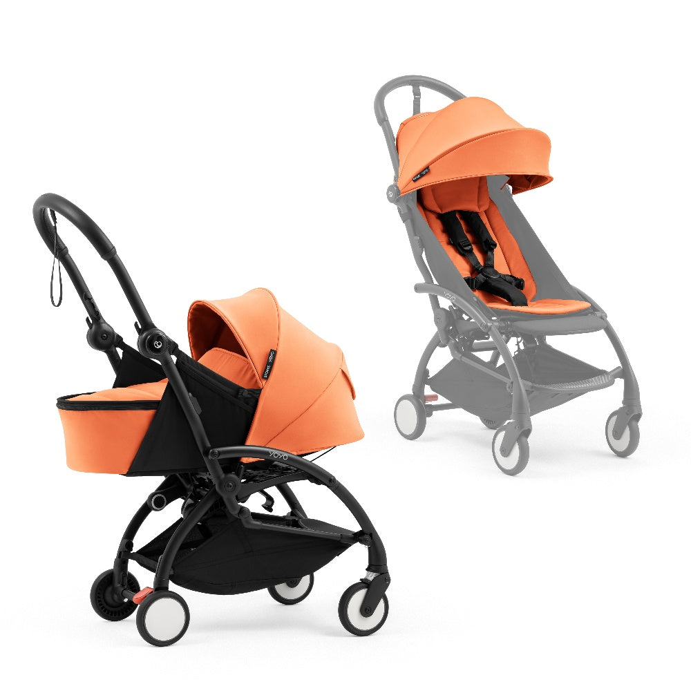 A black stroller newborn travel system shown in orange, with a stroller behind it to demonstrate compatibility, on a clean white background.