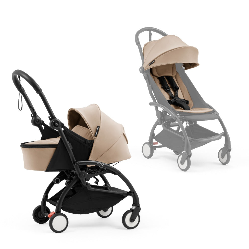 A black stroller newborn travel system shown in beige, with a stroller behind it to demonstrate compatibility, on a clean white background.