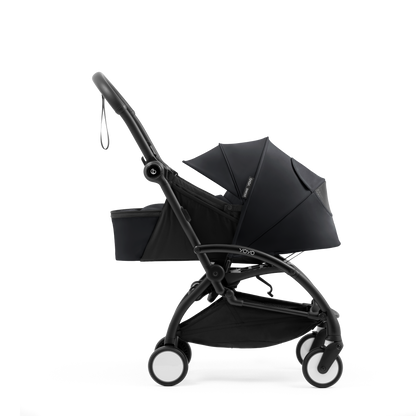 A yoyo stroller bassinet attachment set in black, shown mounted on a stroller frame against a solid white background.