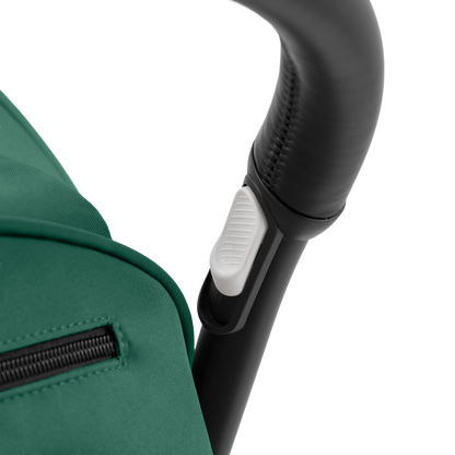 A compact yoyo 5 stroller with a green canopy and seat lining, a black frame, and black wheels, shown on a plain white background.