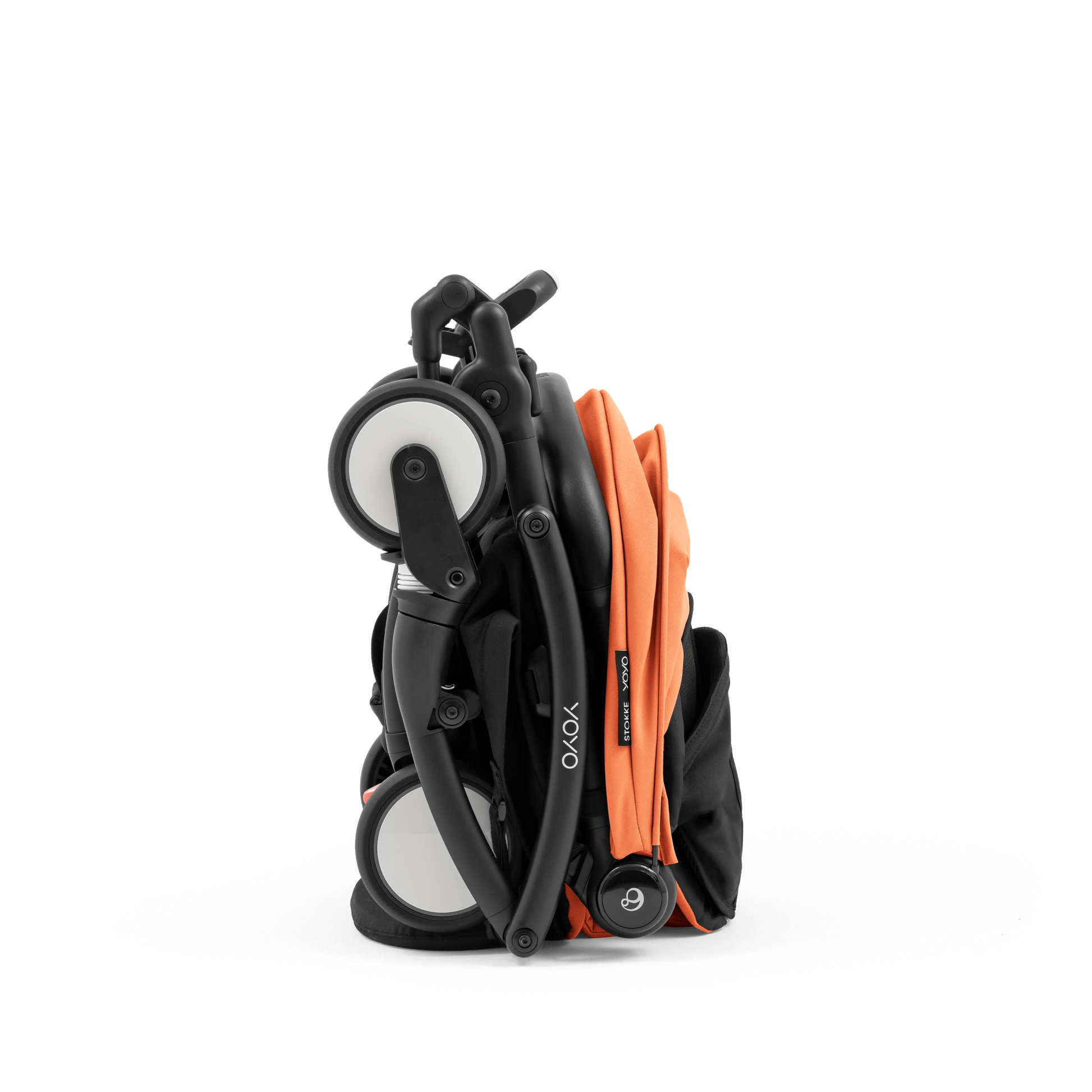 A compact yoyo 5 stroller with a peach orange canopy and seat lining, a black frame, and black wheels, shown on a plain white background.