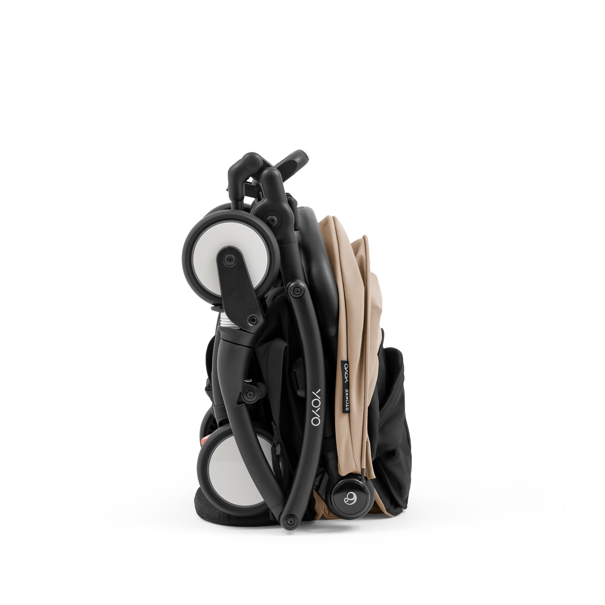 A compact yoyo 5 stroller with a beige canopy and seat lining, a black frame, and black wheels, shown on a plain white background.