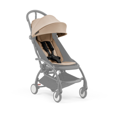 A compact baby stroller with a beige canopy and beige padded seat, with a blacked out chassis, shown on a plain white background.