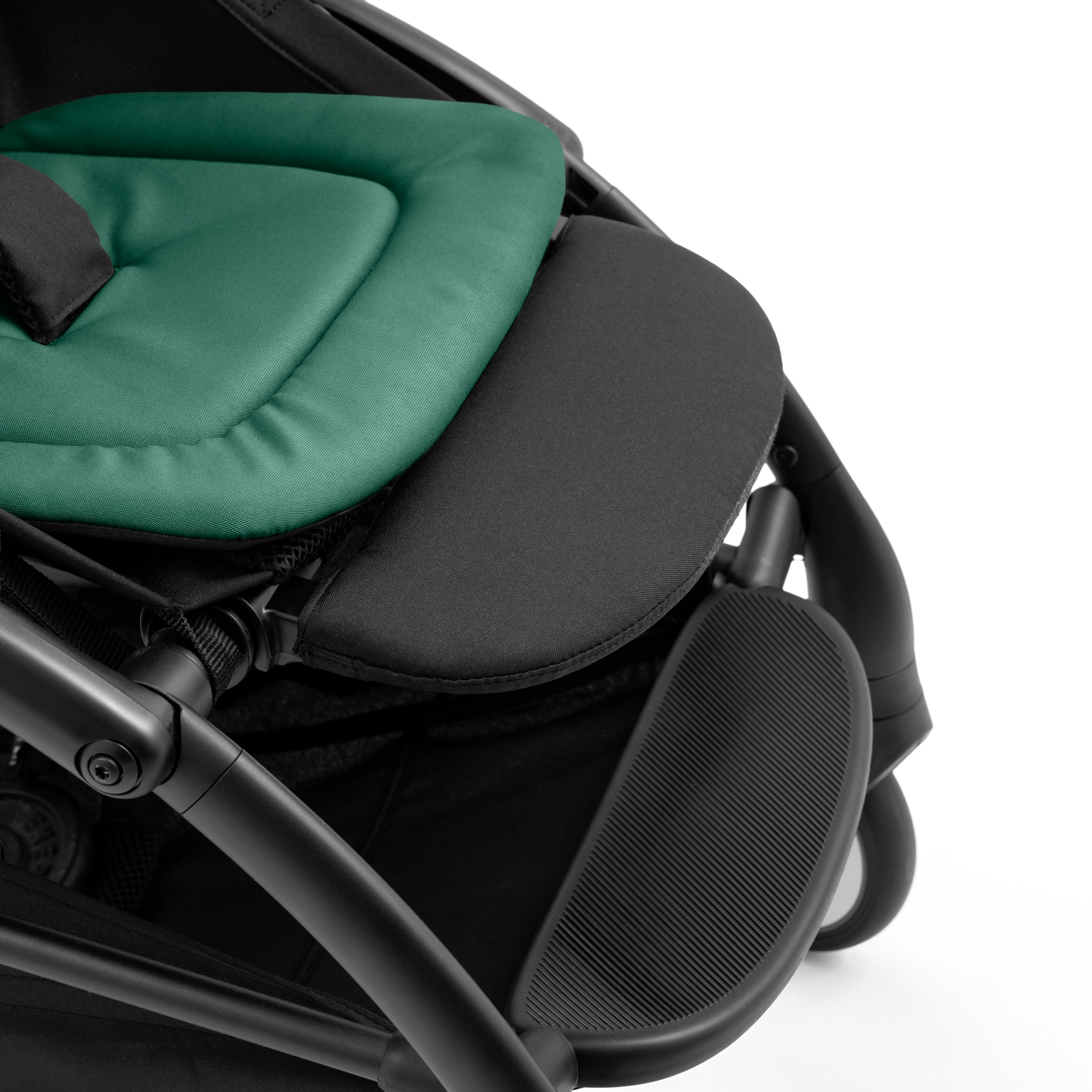A compact yoyo 5 stroller with a green canopy and seat lining, a black frame, and black wheels, shown on a plain white background.