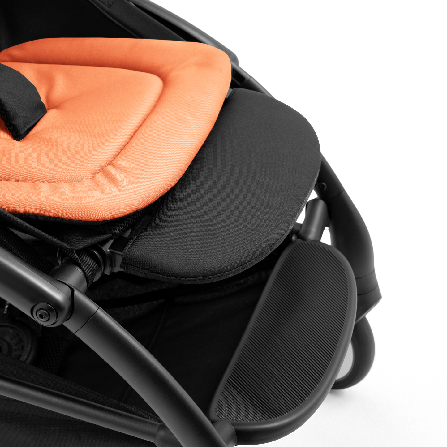 A compact yoyo 5 stroller with a peach orange canopy and seat lining, a black frame, and black wheels, shown on a plain white background.